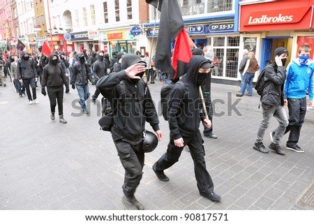 LONDON - MARCH 26: A breakaway group of protesters march through the streets of the British capital during a large anti-cuts rally on March 26, 2011 in London, UK.