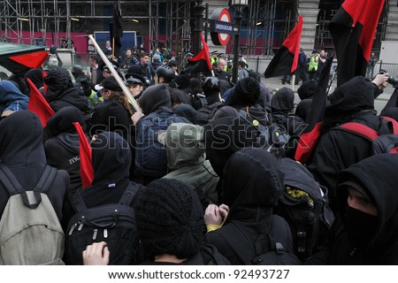 LONDON - MARCH 26: A breakaway group of protesters push through police lines on Picaddilly during a large austerity rally on March 26, 2011 in London, UK.