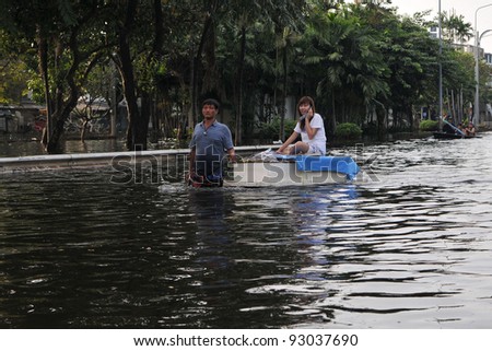 BANGKOK - NOV 4: Residents of Pinklao district make their way along a flooded section of road by boat as Thailand faces its worst flooding in 50 years on Nov 4, 2011 in Bangkok, Thailand.