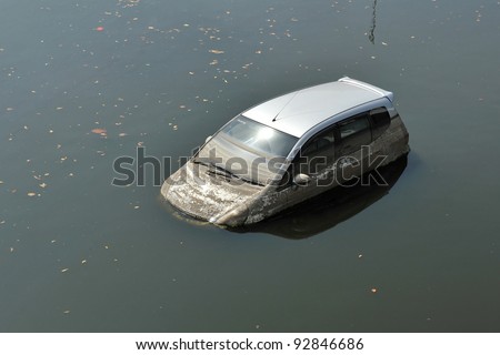 BANGKOK - NOV 18: A flooded car in a parking lot at Don Mueang International Airport, which is closed due to the severe flooding on Nov 18, 2011 in Bangkok, Thailand.