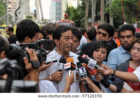 BANGKOK - MAR 5: An unidentified local government official gives an interview to journalists as firefighters tackle a blaze at Fico Building on Mar 5, 2012 in Bangkok, Thailand.