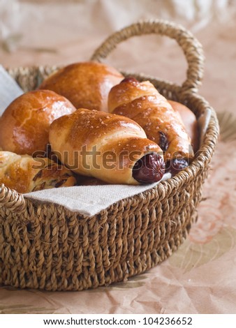 Sausage in dough for  breakfast in basket, selective focus