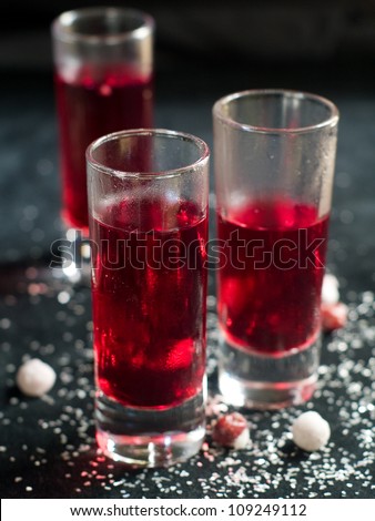 Hard liquor shots with cranberry, selective focus