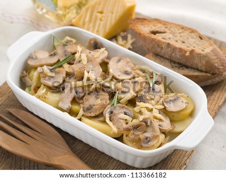 Potato with edible mushroom and cheese over casserole, selective focus
