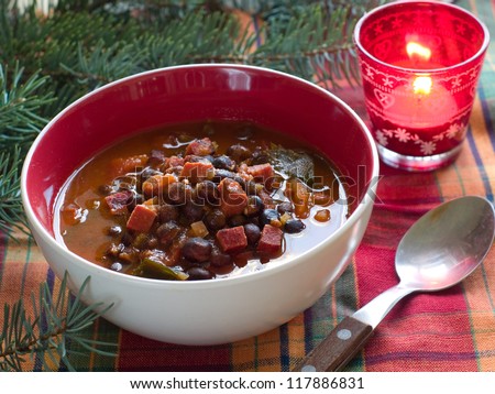 Winter soup with peas and chorizo sausage, selective focus