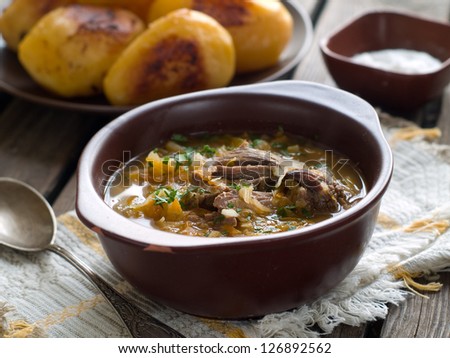 A bowl of vegetable soup with sour cabbage, selective focus