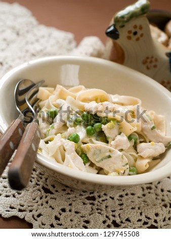 Tagliatelle with chicken and peas, vintage style, selective focus