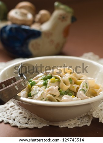 Tagliatelle with chicken and peas, vintage style, selective focus
