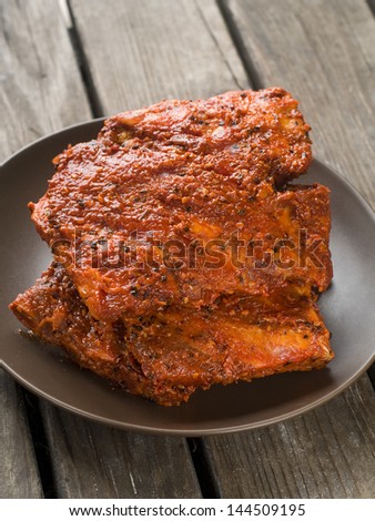 BBQ spare ribs marinated in tomato sauce with pepper, selective focus