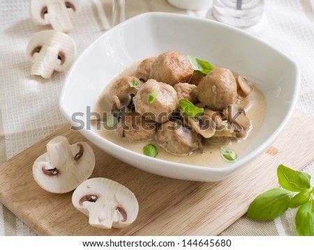 Meatballs with mushroom sauce and basil, selective focus