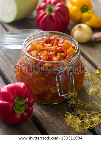 Tomato, pepper and zucchini preserves in glass jar. Selective focus