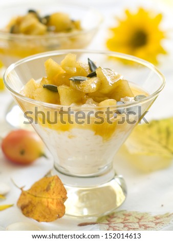 Creamed rice pudding with apple and pumpkin seed, selective focus