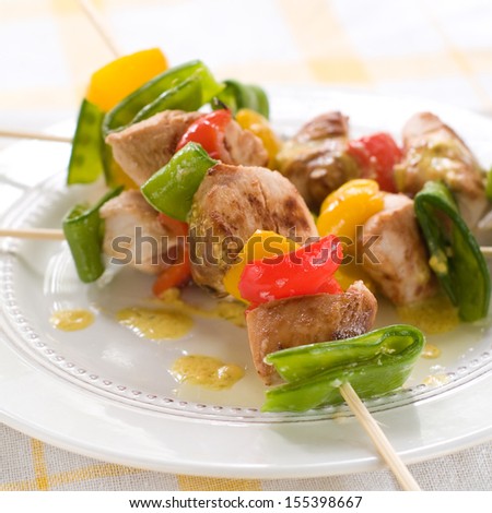 Grilled chicken and vegetable kebab with sauce, selective focus
