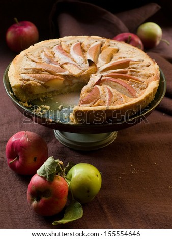 Apple pie on cake stand in vintage style, low key, selective focus