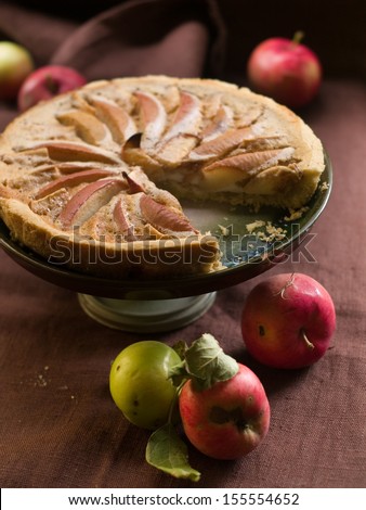 Apple pie on cake stand in vintage style, low key, selective focus