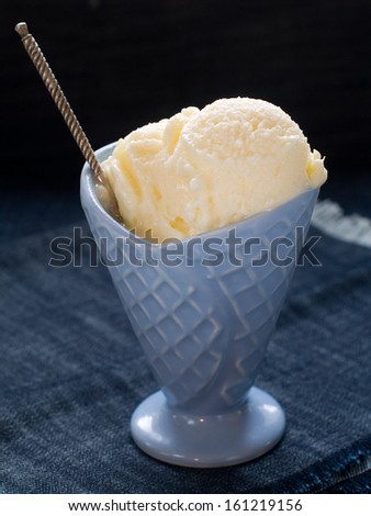 Lemon ice cream in bowl, selective focus