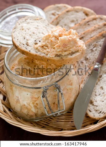 Fish, soft cheese and egg pate in glass jar, selective focus