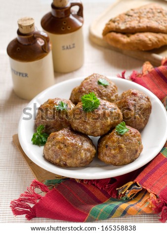 Meat balls on white plate with parsley, selective focus