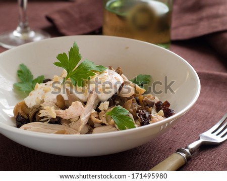 Salad with chicken, mushrooms,  prune and nut, selective focus