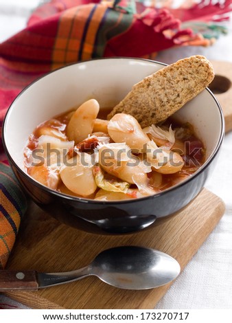 A bowl of homemade chili bean soup with cheese, selective focus