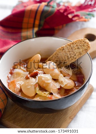 A bowl of homemade chili bean soup with cheese, selective focus