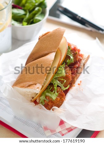 Homemade sandwich with meatball and marinara sauce and cheese, selective focus