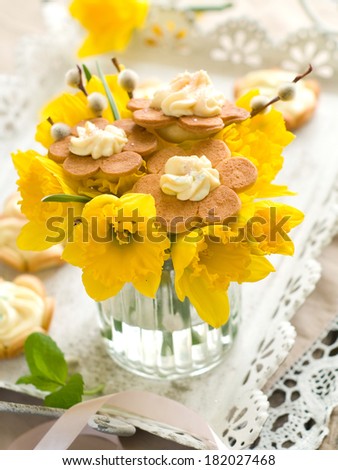 Bouquet of fresh narcissus, willow and easter cookie for Easter, selective focus