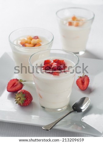 Glass with fruit and berry yogurt , selective focus