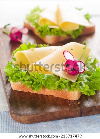 Delicious sandwich with cheese and radish like a mouse for kids party, selective focus