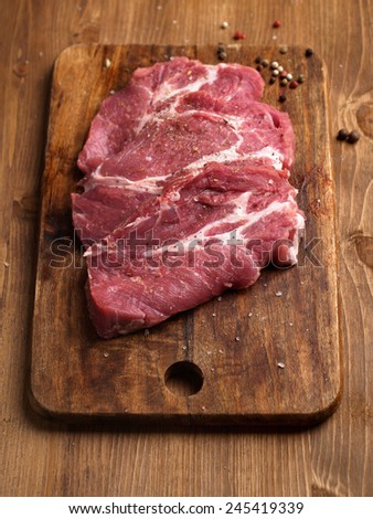 Raw fresh meat on wooden board, selective focus