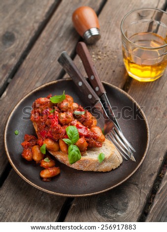 Bean salad with tomato sauce on bread, selective focus