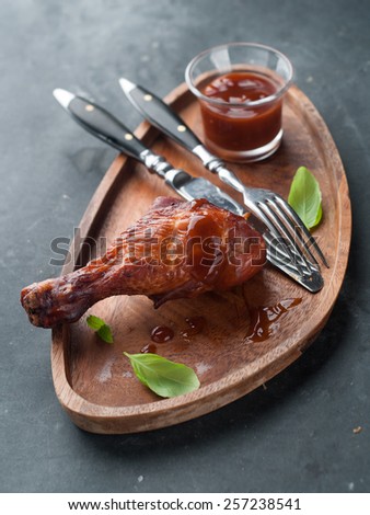 Roasted chicken leg with sauce, selective focus