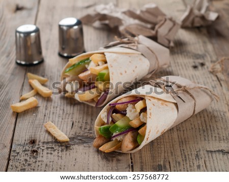 Fresh tortilla wraps with grilled chicken,vegetables and potato, selective focus
