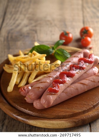 Grilled sausage with tomato sauce and potatoes, selective focus