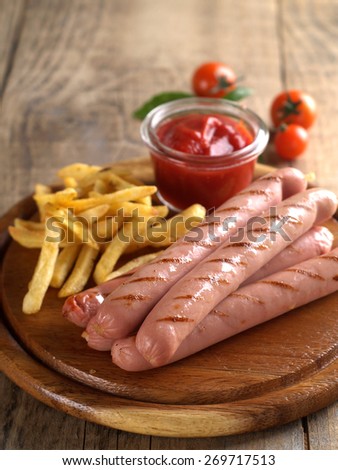 Grilled sausage with tomato sauce and potatoes, selective focus