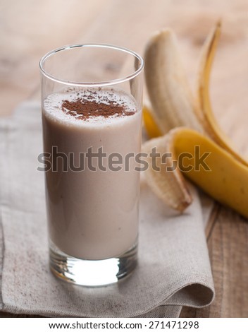 Chocolate and banana smoothie (milkshake) in glass, selective focus