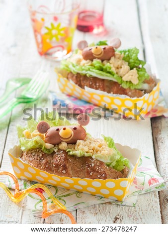 Delicious sandwiches with sausage like a bear for kids party, selective focus