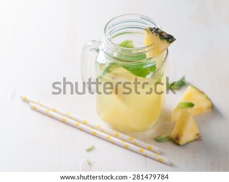 Pineapple lemonade with lemon and mint, selective focus