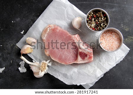 Raw fresh meat with spices on dark background, selective focus