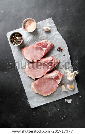 Raw fresh meat with spices on dark background, selective focus