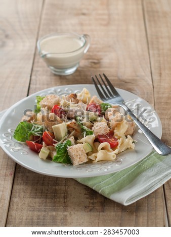 Pasta salad with chicken, tomato, cheese and sauce, selective focus