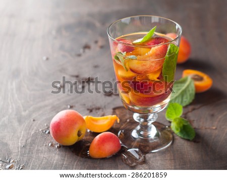 Summer drink with apricot ( or peach)  in glass, selective focus