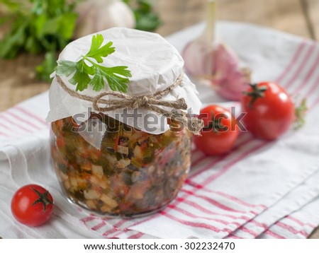 Tomato, pepper, celery and zucchini preserves in glass jar, selective focus