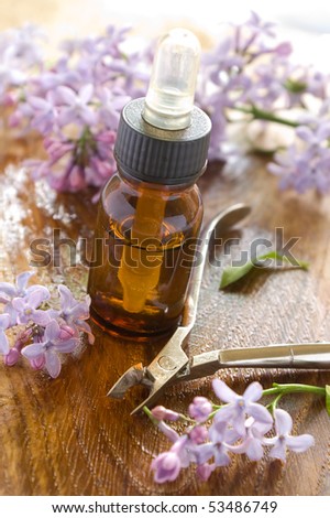 Massage oil for nail and manicure scissors. Lilac on background. Could be a generic toiletry.