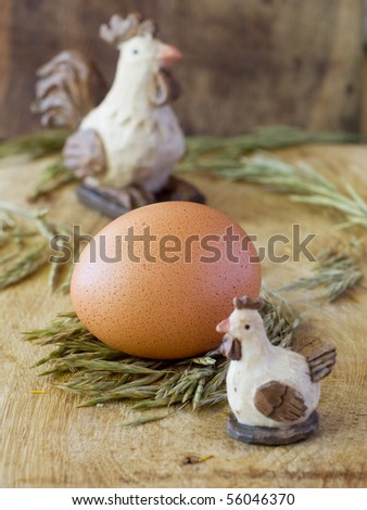 Egg on the board with toys chicken