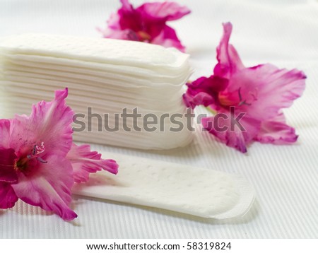Hygiene pad with pink lily on white background