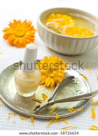 Device for manicure. Yellow Chamomile on background. Could be a generic toiletry.