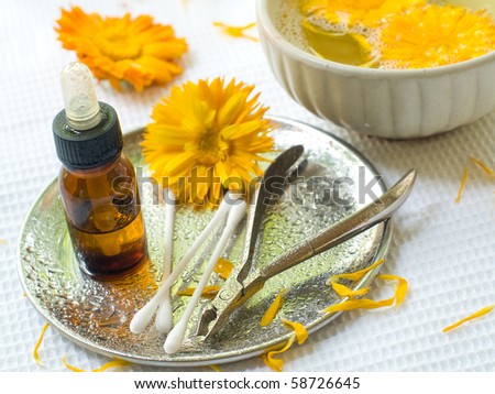 Device for manicure.Yellow Chamomile on background. Could be a generic toiletry.