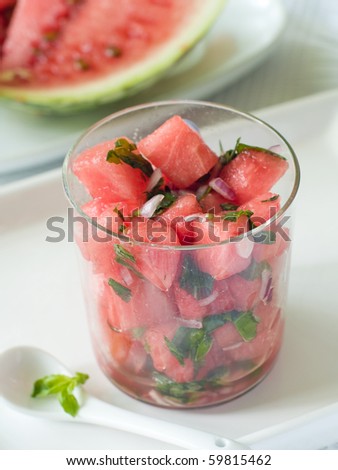 Watermelon salsa with red onion in glass