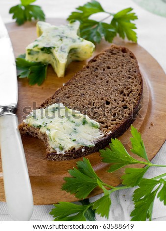 Bread and butter with knife on plate